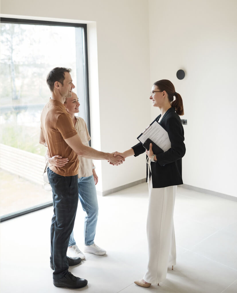 man shaking hand with a real estate agent in a beige room
